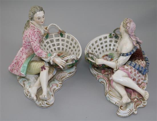 A pair of English porcelain figural sweetmeat dishes, mid 19th century, after the Meissen originals, length 29cm, restorations